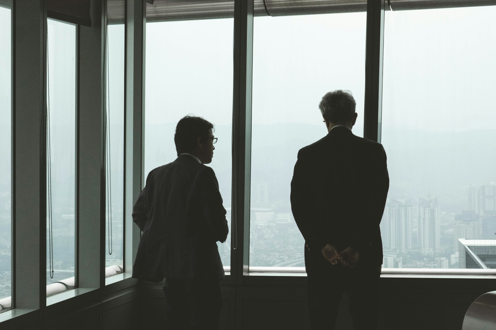 two men standing near window