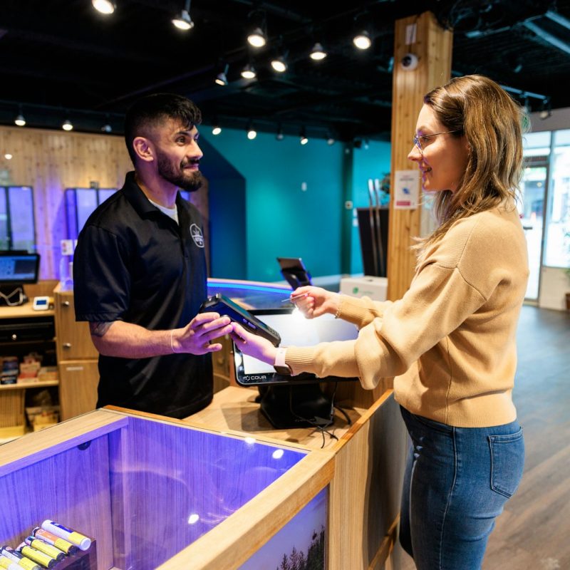 a man and a woman standing in front of a fish tank